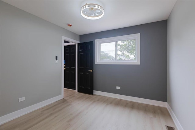 10011 S Princeton Ave, Chicago, IL 60628 - empty room featuring wood finished floors and baseboards