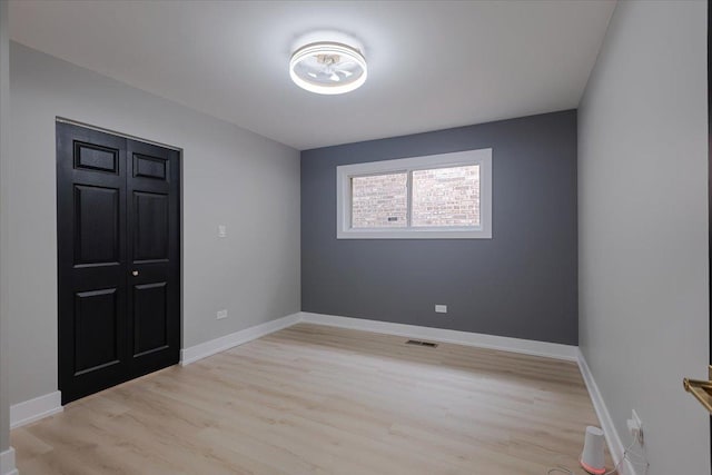 10011 S Princeton Ave, Chicago, IL 60628 - unfurnished bedroom with light wood-style flooring and baseboards
