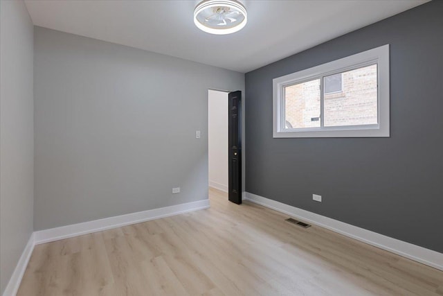 10011 S Princeton Ave, Chicago, IL 60628 - spare room with light wood-type flooring and baseboards