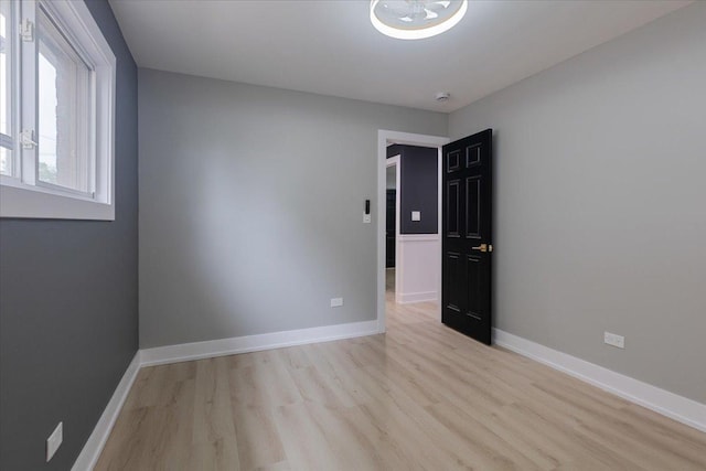 10011 S Princeton Ave, Chicago, IL 60628 - unfurnished room featuring light wood-style floors and a smoke detector
