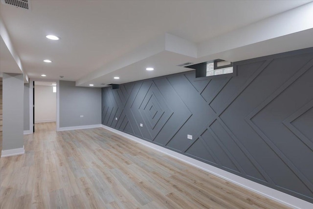 10011 S Princeton Ave, Chicago, IL 60628 - finished below grade area with light wood finished floors, recessed lighting, and a decorative wall