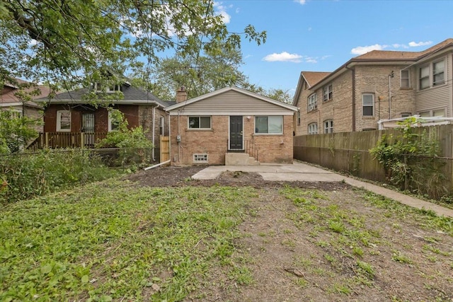 10011 S Princeton Ave, Chicago, IL 60628 - rear view of property featuring brick siding and a patio