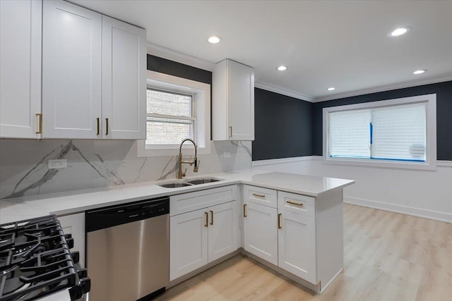 10011 S Princeton Ave, Chicago, IL 60628 - kitchen featuring dishwasher, a peninsula, light countertops, crown molding, and light wood-style floors