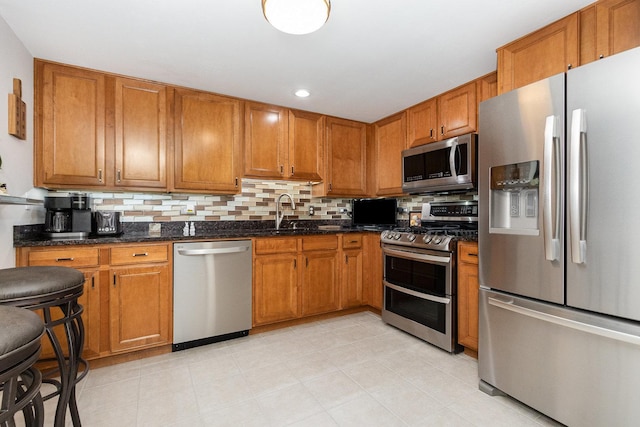 845 E 22nd St Unit 219, Lombard, IL 60148 - kitchen featuring appliances with stainless steel finishes, brown cabinets, decorative backsplash, dark stone countertops, and recessed lighting