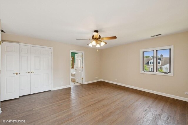 108 Yost Ave, Park Ridge, IL 60068 - unfurnished bedroom with wood finished floors, a closet, connected bathroom, and a ceiling fan