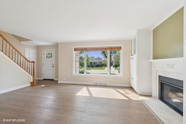 108 Yost Ave, Park Ridge, IL 60068 - unfurnished living room with stairs, crown molding, light wood finished floors, and a fireplace with flush hearth