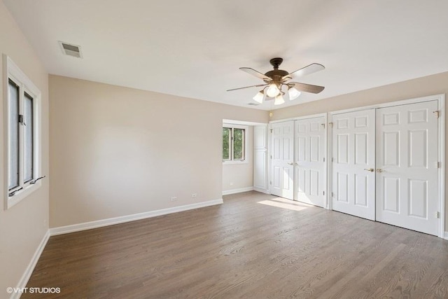 108 Yost Ave, Park Ridge, IL 60068 - unfurnished bedroom with two closets, wood finished floors, and a ceiling fan
