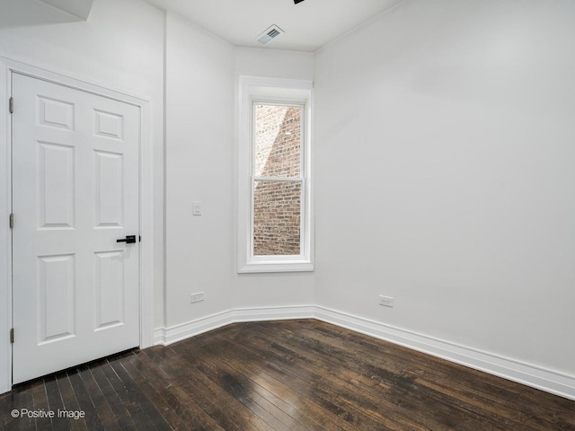 5427 S Carpenter St, Chicago, IL 60609 - spare room featuring dark wood finished floors and baseboards