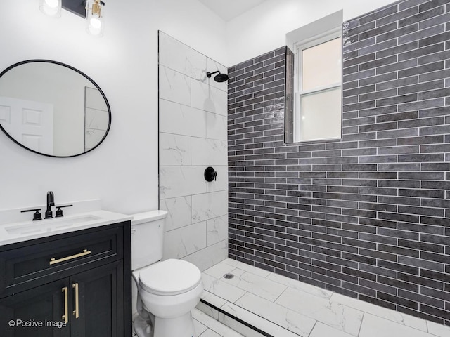 5427 S Carpenter St, Chicago, IL 60609 - bathroom featuring tiled shower, vanity, and marble finish flooring