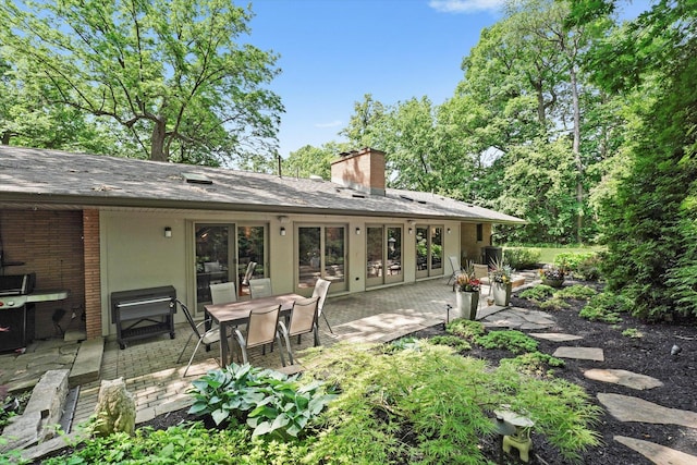 4770 Woodcliff Ln, Palatine, IL 60067 - back of house with a patio, a chimney, a shingled roof, and brick siding