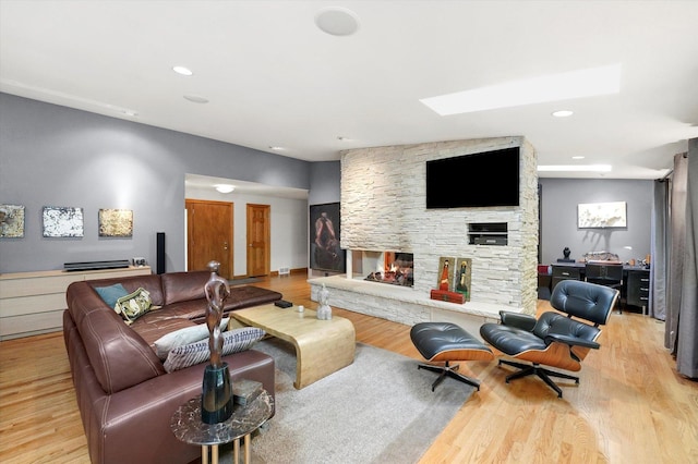 4770 Woodcliff Ln, Palatine, IL 60067 - living room featuring a fireplace, a skylight, light wood-style flooring, and recessed lighting