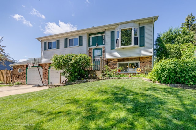 161 Olympic Dr, Bolingbrook, IL 60440 - view of front facade featuring brick siding, concrete driveway, an attached garage, and a front yard