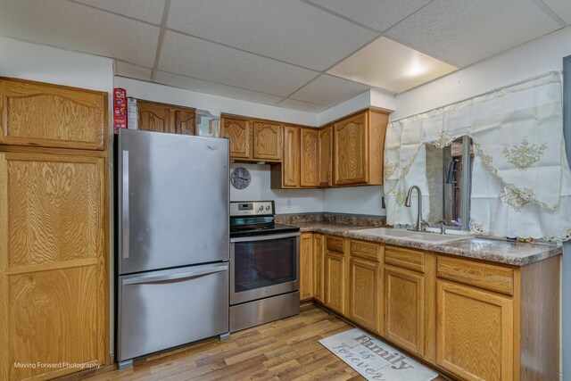 161 Olympic Dr, Bolingbrook, IL 60440 - kitchen with stainless steel appliances, a drop ceiling, light wood finished floors, brown cabinetry, and dark countertops