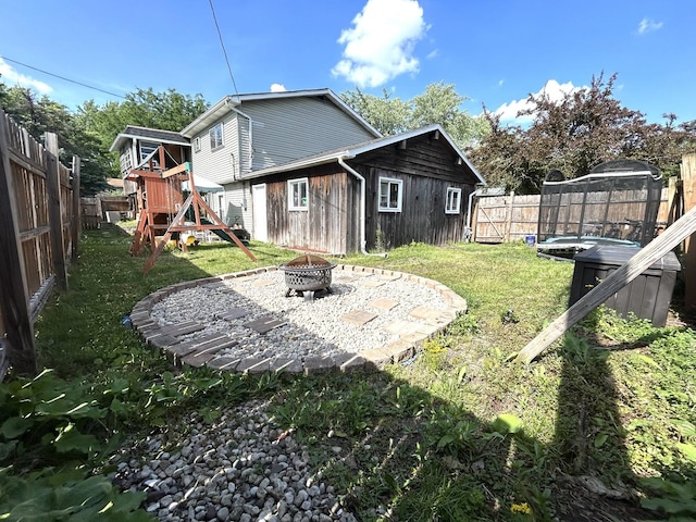 161 Olympic Dr, Bolingbrook, IL 60440 - rear view of house with a playground, an outdoor fire pit, and a fenced backyard