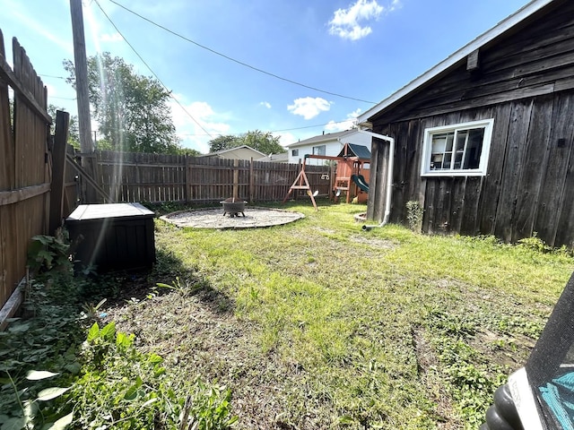 161 Olympic Dr, Bolingbrook, IL 60440 - fenced backyard with a playground and a fire pit