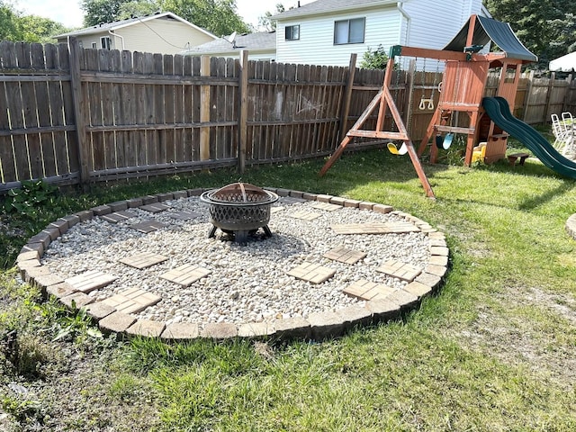161 Olympic Dr, Bolingbrook, IL 60440 - fenced backyard featuring a fire pit and a playground