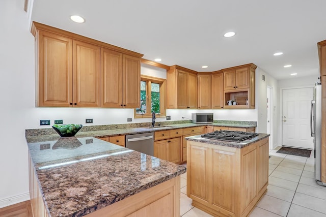 1700 Cornell Ct, Lake Forest, IL 60045 - kitchen featuring appliances with stainless steel finishes, a peninsula, recessed lighting, dark stone counters, and a center island