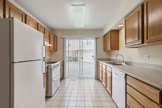 9207 E Prairie Rd, Evanston, IL 60203 - kitchen featuring white appliances, light tile patterned floors, light countertops, brown cabinetry, and under cabinet range hood