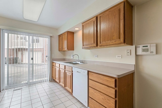 9207 E Prairie Rd, Evanston, IL 60203 - kitchen featuring dishwasher, light countertops, light tile patterned floors, and brown cabinets
