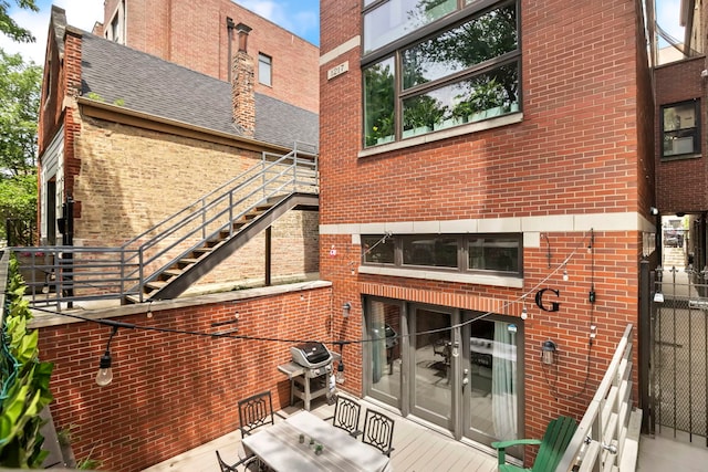 1217 N Greenview Ave Unit G, Chicago, IL 60642 - rear view of house with stairway, brick siding, and a shingled roof