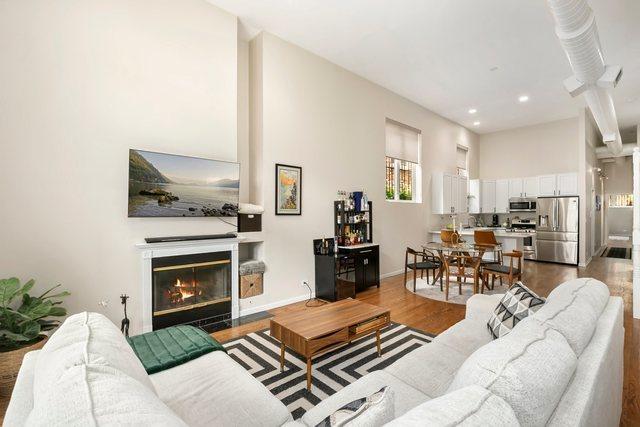 1217 N Greenview Ave Unit G, Chicago, IL 60642 - living room featuring wood finished floors, a fireplace with flush hearth, and recessed lighting