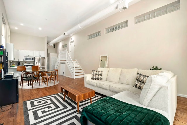 1217 N Greenview Ave Unit G, Chicago, IL 60642 - living area with a towering ceiling, wood finished floors, stairway, and recessed lighting