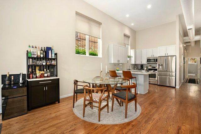 1217 N Greenview Ave Unit G, Chicago, IL 60642 - dining room featuring light wood-type flooring, a dry bar, a high ceiling, and recessed lighting