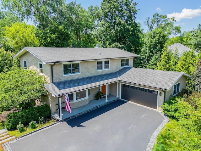 821 Sandstone Dr, Libertyville, IL 60048 - view of front facade with an attached garage and asphalt driveway