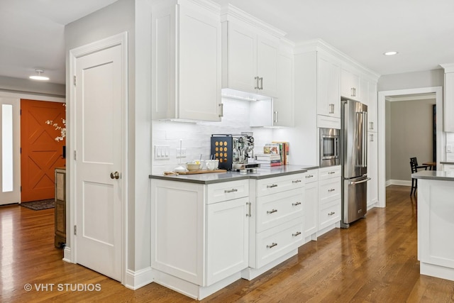 821 Sandstone Dr, Libertyville, IL 60048 - kitchen with stainless steel appliances, wood finished floors, white cabinets, backsplash, and recessed lighting