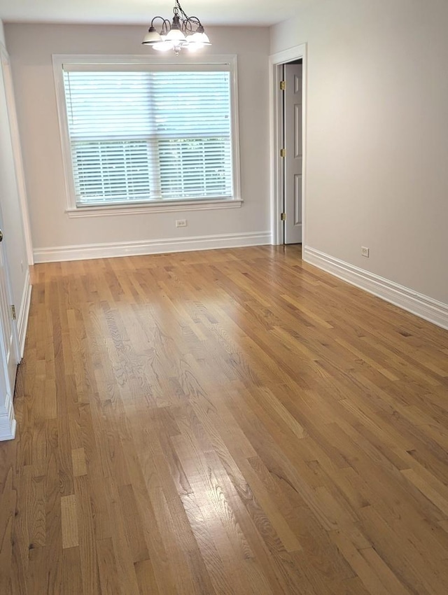 11360 195th St, Mokena, IL 60448 - unfurnished room with light wood-type flooring, a chandelier, and healthy amount of natural light