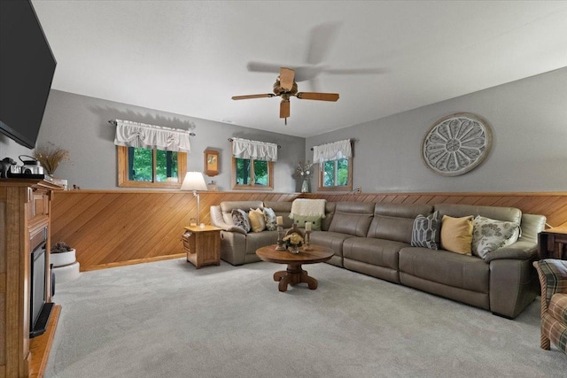 3583 Newport Dr, Island Lake, IL 60042 - carpeted living room with a wainscoted wall, a ceiling fan, wood walls, and a fireplace