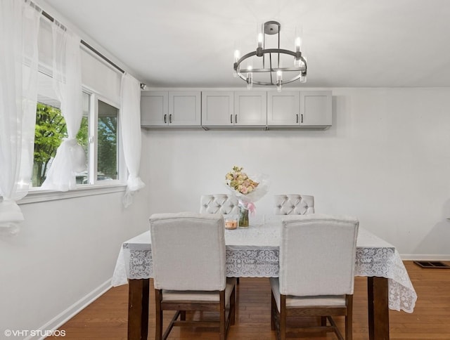 2110 Hermon Ave, Zion, IL 60099 - dining room featuring a chandelier and dark wood-type flooring
