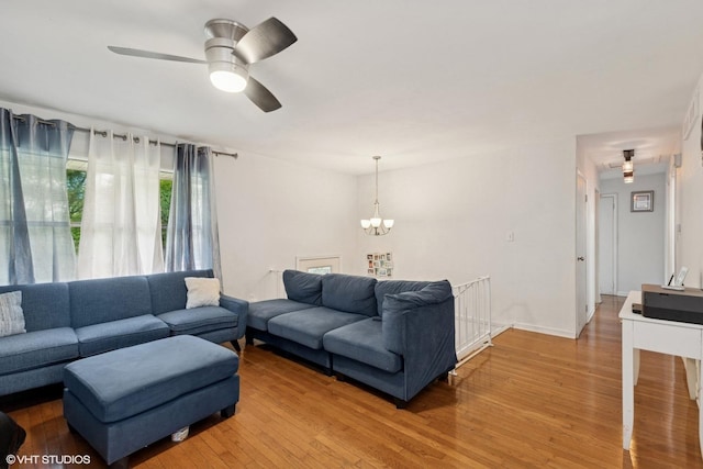 2110 Hermon Ave, Zion, IL 60099 - living area featuring light wood finished floors, a chandelier, and a ceiling fan