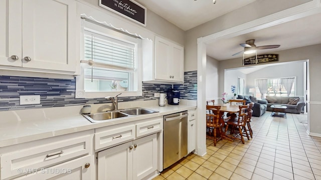 7525 N Overhill Ave, Chicago, IL 60631 - kitchen with dishwasher, decorative backsplash, light tile patterned flooring, white cabinets, and light countertops