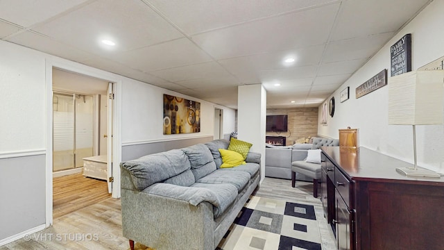 7525 N Overhill Ave, Chicago, IL 60631 - living room featuring light wood finished floors, a paneled ceiling, recessed lighting, and a lit fireplace