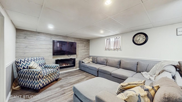7525 N Overhill Ave, Chicago, IL 60631 - living room with wood walls, wood finished floors, a glass covered fireplace, a drop ceiling, and recessed lighting