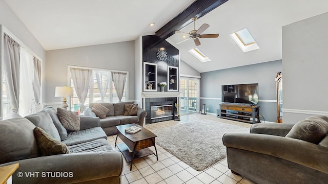 7525 N Overhill Ave, Chicago, IL 60631 - living room featuring a skylight, a ceiling fan, a tiled fireplace, beamed ceiling, and light tile patterned floors
