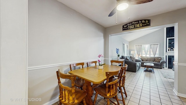 7525 N Overhill Ave, Chicago, IL 60631 - dining space with vaulted ceiling, light tile patterned floors, ceiling fan, and a tile fireplace