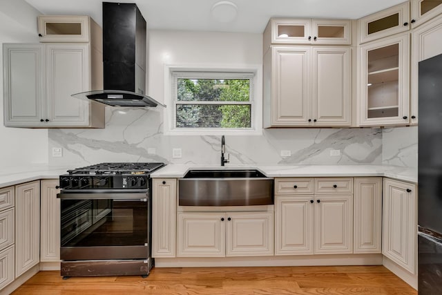 1115 N Taylor Ave, Oak Park, IL 60302 - kitchen with black gas stove, wall chimney range hood, high quality fridge, and backsplash