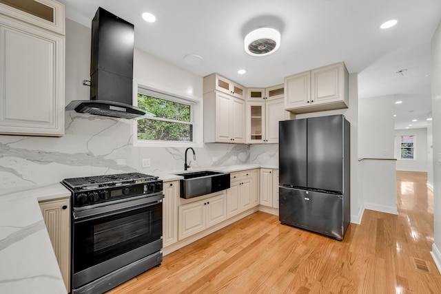 1115 N Taylor Ave, Oak Park, IL 60302 - kitchen featuring freestanding refrigerator, gas range oven, wall chimney range hood, light wood-type flooring, and light stone countertops