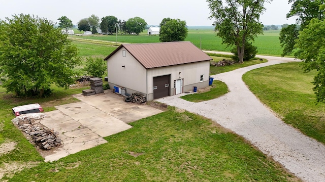 382 Keigwin Rd, Walnut, IL 61376 - view of property exterior featuring a rural view, an outdoor structure, a lawn, and a garage