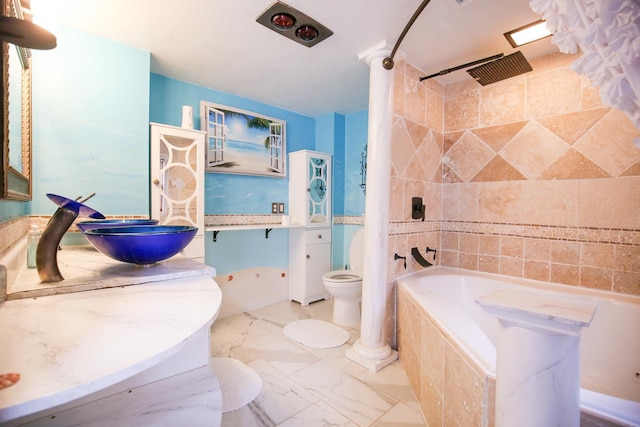 382 Keigwin Rd, Walnut, IL 61376 - bathroom featuring tiled shower / bath combo, vanity, and marble look tiles