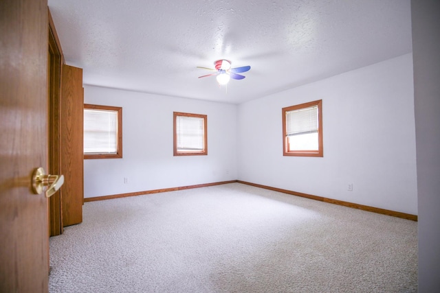 382 Keigwin Rd, Walnut, IL 61376 - unfurnished room with healthy amount of natural light, light carpet, a textured ceiling, and a ceiling fan