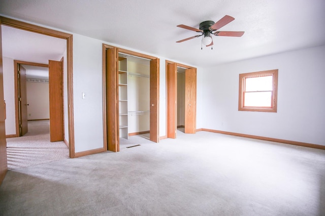 382 Keigwin Rd, Walnut, IL 61376 - unfurnished bedroom featuring two closets, carpet, and a ceiling fan