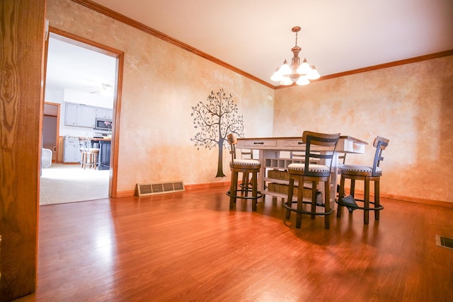 382 Keigwin Rd, Walnut, IL 61376 - dining room with wood finished floors, a chandelier, and ornamental molding