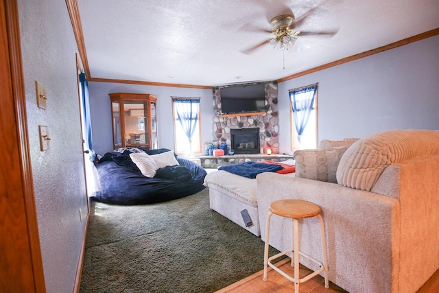 382 Keigwin Rd, Walnut, IL 61376 - living room with crown molding, healthy amount of natural light, a fireplace, ceiling fan, and wood finished floors