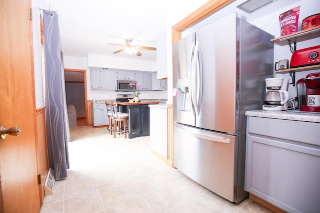 382 Keigwin Rd, Walnut, IL 61376 - kitchen with appliances with stainless steel finishes, gray cabinetry, a ceiling fan, and light countertops
