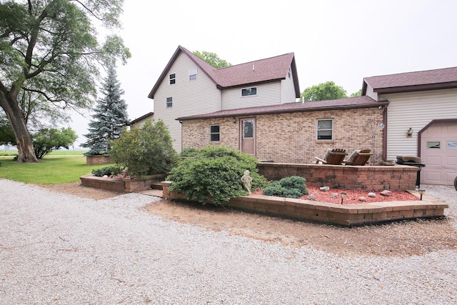 382 Keigwin Rd, Walnut, IL 61376 - view of property exterior with brick siding, a garage, and a shingled roof