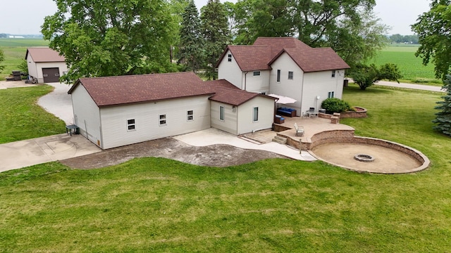382 Keigwin Rd, Walnut, IL 61376 - rear view of house featuring a patio, a lawn, and an outdoor fire pit