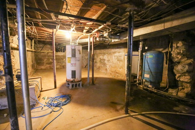 382 Keigwin Rd, Walnut, IL 61376 - unfinished basement featuring electric water heater and a water pressure tank